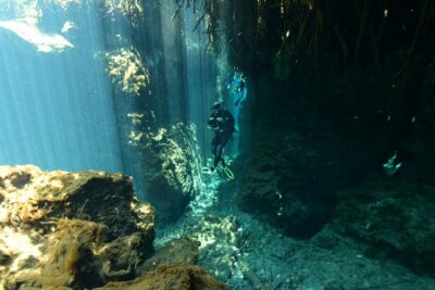 Light shafts falling into a flooded limestone cavern