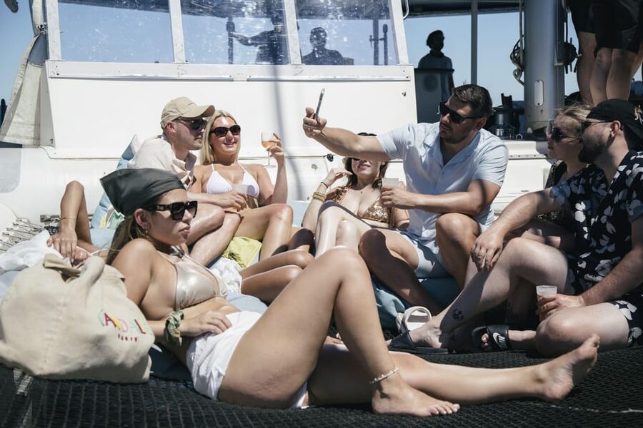 Lisbon: Catamaran Boat Party with Music, Open Bar & Dives - Getting into the water
